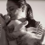 A tender moment captured between a woman and her cat in Heredia, Costa Rica.